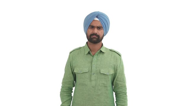 Portrait of angry Indian man shaking index finger in front of the camera in prohibition gesture. Finger wag. Isolated on white background