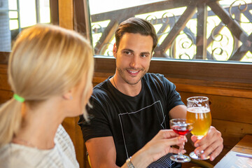 Attractive couple toasting in the cafe bar