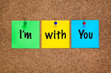 Three colored notes on cork board with words I&rsquo;m with You.