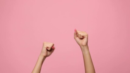 woman hands making thumbs up gesture, holding fists in the air and celebrating, clapping on pink background - Powered by Adobe