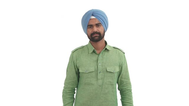 Portrait of Indian man calling someone with folded and straightened his fingers. Beckoning Indian gesture. Come here. Isolated on white background