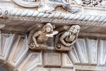 Close up of the sculptures on the façade of Castello Acquaviva, house of the city council, made by the local Leccese sandstone ("pietra leccese") in Nardò, near Lecce, Puglia region, Italy.