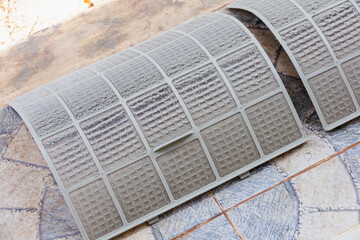 close up on air conditioner filter is very dirty after remove from unit wait clean