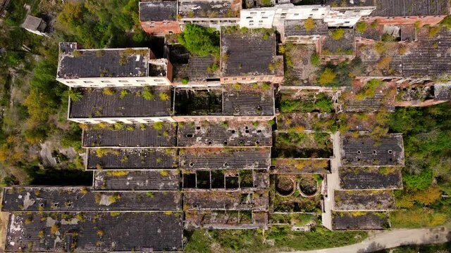 View from above. Khrustalnensky mining and processing plant. The camera is lifted over the destroyed abandoned buildings of a large tin mining plant