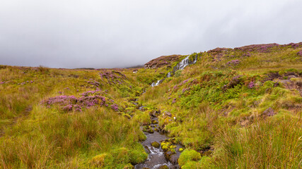 Little waterfall at Loch Leathan in Portree in Scotland (Isle of Skye)