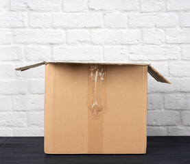 open empty rectangular box made of brown corrugated cardboard