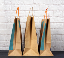brown paper bag with handles on white brick wall background