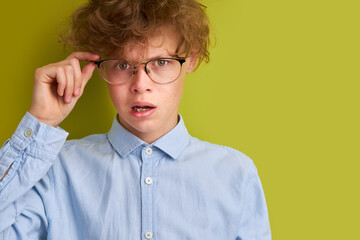 caucasian curly boy misunderstanding something, he is frustrated, emotionally react on news