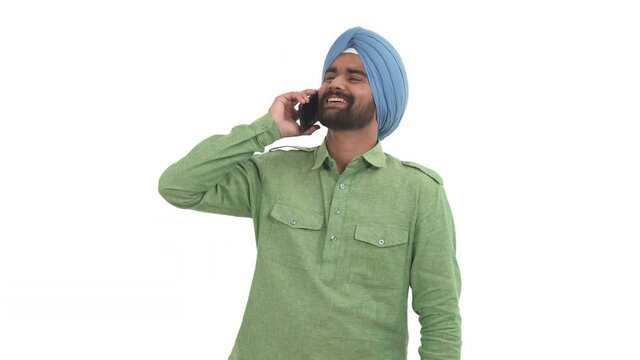 Portrait of beard Indian man picks up the phone, having friendly conversation and gesticulating vigorously. Isolated on white background