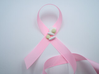 Breat cancer pink ribbon symbol kept on Tablets and pills,OLYMPUS DIGITAL CAMERA