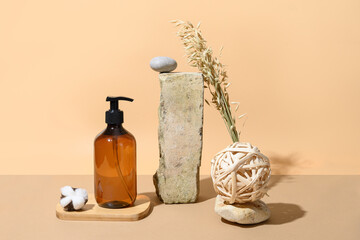 SPA natural accessories, bottle with cosmetic or body care on beige background. Natural skin care. Wellness. Creative composition with podium.