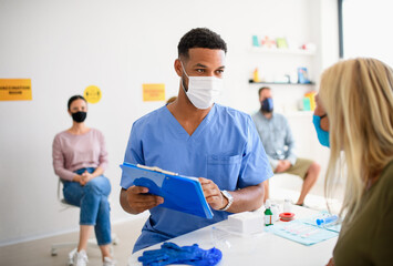 People with face mask getting vaccinated, coronavirus, covid-19 and vaccination concept.