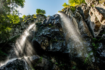 Obraz premium A large waterfall in a forest. Beautiful natural landscape of the Boyana Waterfall in Bulgaria