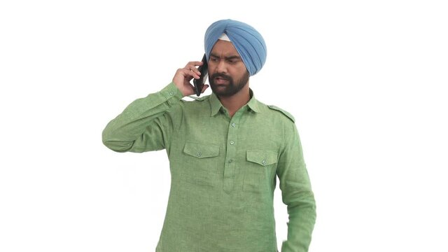 Indian beard man picks up smart phone and having heavy talk. Guy emotionally gesticulating, swearing with someone. Isolated on white background