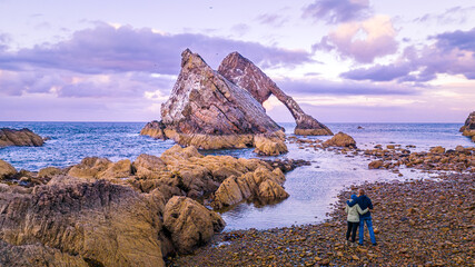 Bow Fiddle Rock during sunset - A natural sea arch near Portknockie on the north-eastern coast of...