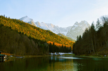 Riessersee with reflection of mountains on water surface in picturesque Fall time scenery and...