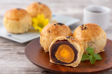 Moon cake yolk pastry, mooncake for Mid-Autumn Festival holiday, top view design concept on bright wooden table with copy space