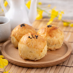 Moon cake yolk pastry, mooncake for Mid-Autumn Festival holiday, top view design concept on bright wooden table with copy space