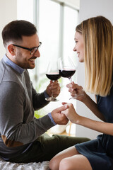 Valentine's day, birthday, celebration concept. Romantic happy couple in love drinking wine at date.