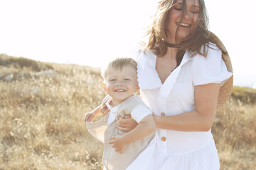 Beautiful woman with a child in nature. High quality photo.