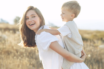 Beautiful woman with a child in nature. High quality photo.