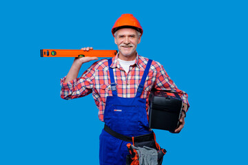 Photo of professional worker  and builder in blue uniform with wall measure and toolbox on hands isolated on modern blue background