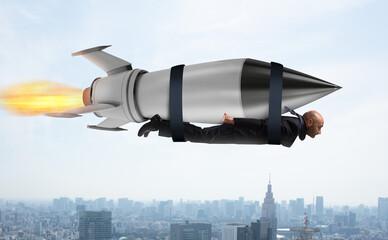 Businessman flies with a fast rocket. Concept of ambition and determination