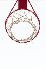 Basketball hoop with white sky in vertical position. View taken from below.
