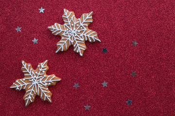 Christmas baking lies on a red background. Christmas gingerbread snowflakes lie for the gala dinner