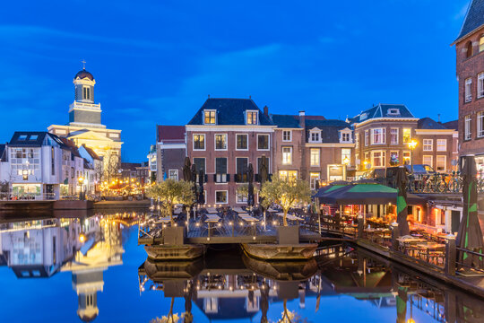 Evening view of the Dutch historic city center with water, terraces and restaurants in Leiden, The Netherlands