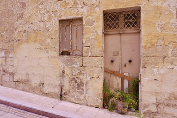 Fototapeta na wymiar Doors and window to abandoned house with shabby wall