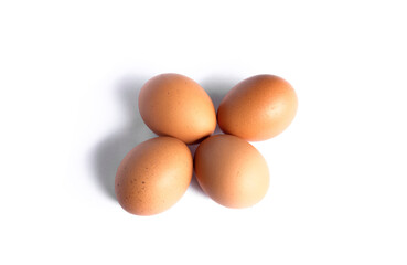 Four chicken eggs isolated on white background.