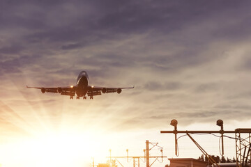 The heavy storm is approaching the airport in cloudy weather. Airplane arrives from the divine...