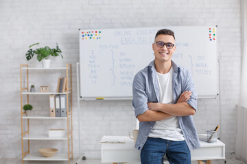 Blog, hobby and remote work from home. Smiling man in glasses with crossed arms makes video for...