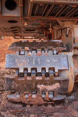 Crawler tracks of a large excavator in clay soil