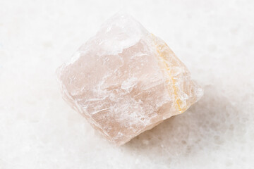 closeup of sample of natural mineral from geological collection - rough pink Fluorite rock on white...