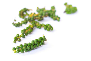 The fresh green peppercorns  on white background