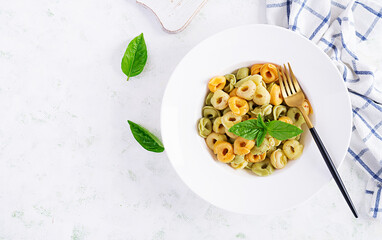 Italian ravioli pasta with spinach and ricotta in white plate. Italian tortellini pasta. Top view, flat lay, overhead