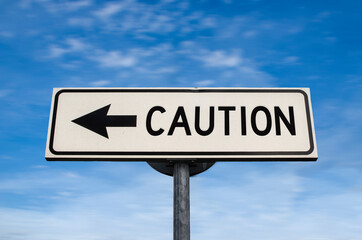 Caution road sign, arrow on blue sky background. One way blank road sign with copy space. Arrow on a pole pointing in one direction.