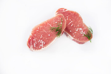 Sliced raw pork meat with salt and parsley isolated on a white background. View from above. Flat lay