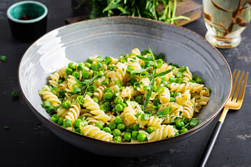Vegan salad. Fusilli pasta with green peas and onions. Italian food.