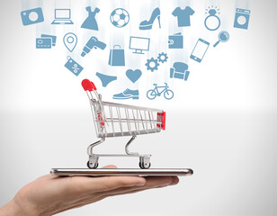 Online store. Collage of male hand holding mobile phone with shopping cart and pictograms of...