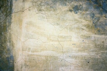 Old plastered wall in cracks for background