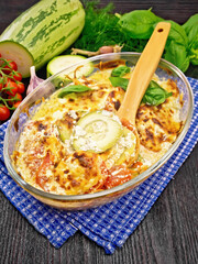 Zucchini baked with tomatoes in glass pan on table