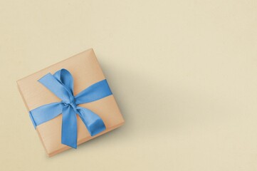Gift box with ribbon on a rough background. Place for text