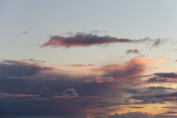Evening sky with rain clouds in orange-pink sunset light