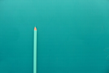 top view of green color pencils on green background 