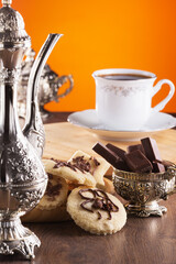 delicious cookies and milk chocolate with an exquisite black coffee