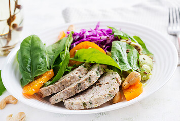 Ketogenic diet. Buddha bowl dish with meatloaf, chicken meat, avocado, cabbage and nuts. Detox and healthy concept. Keto food.