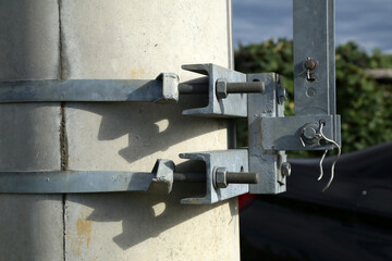 Obraz na płótnie Canvas Clamps with fixing bolts on an electric pylon